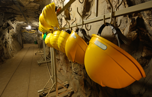 Image of hard hat helmets in a hazardous area with IECEx low-bay ceiling lights for mining & gas applications