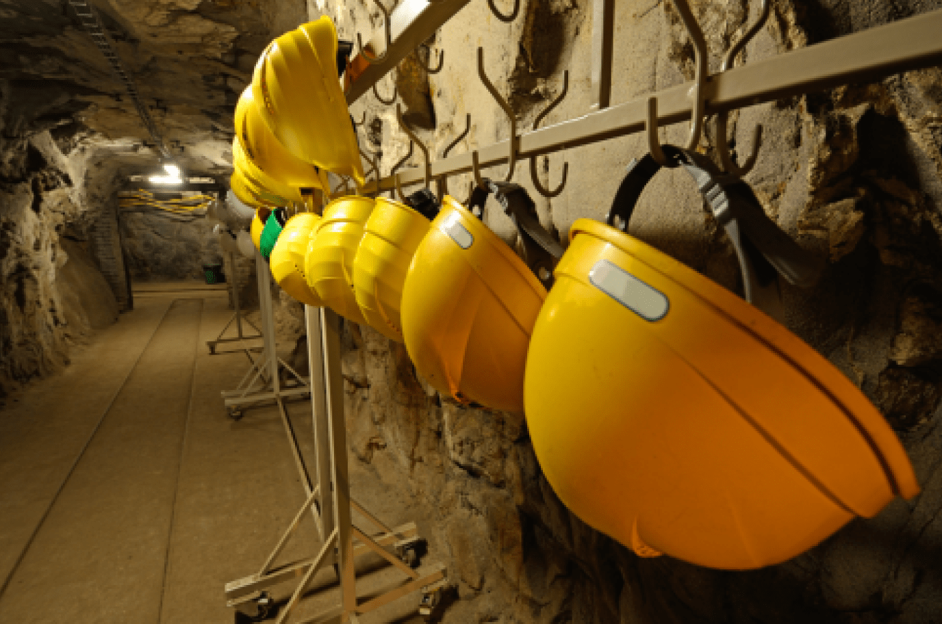 Image of hard hat helmets in a hazardous area with IECEx low-bay ceiling lights for mining & gas applications